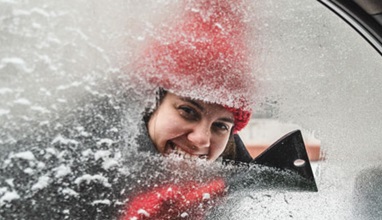 Woman Scraping Ice off Vehicle Window